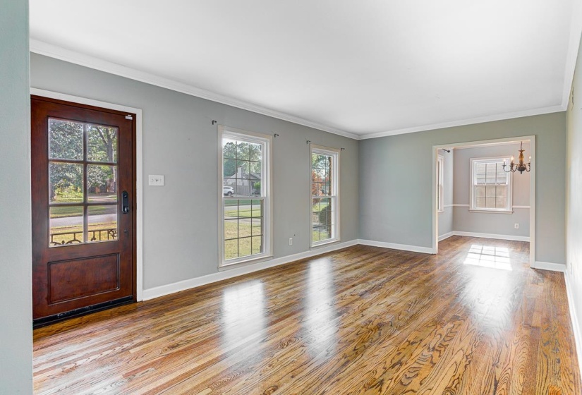 Spacious room featuring wood-finish flooring, 
