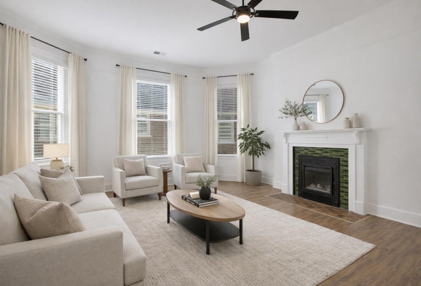 Living room featuring a ceiling fan, wood finished floors, a tile fireplace, and ornamental molding