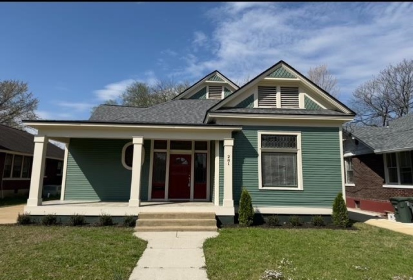 View of front facade with a front lawn and covered porch