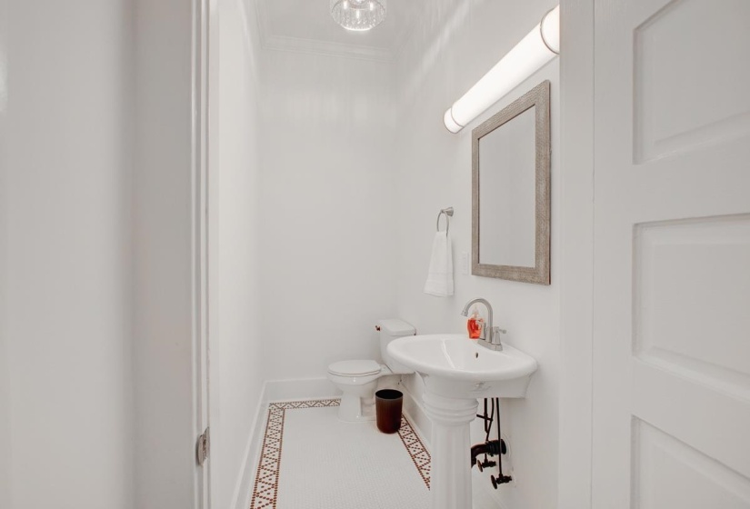 Bathroom with crown molding and tile patterned flooring