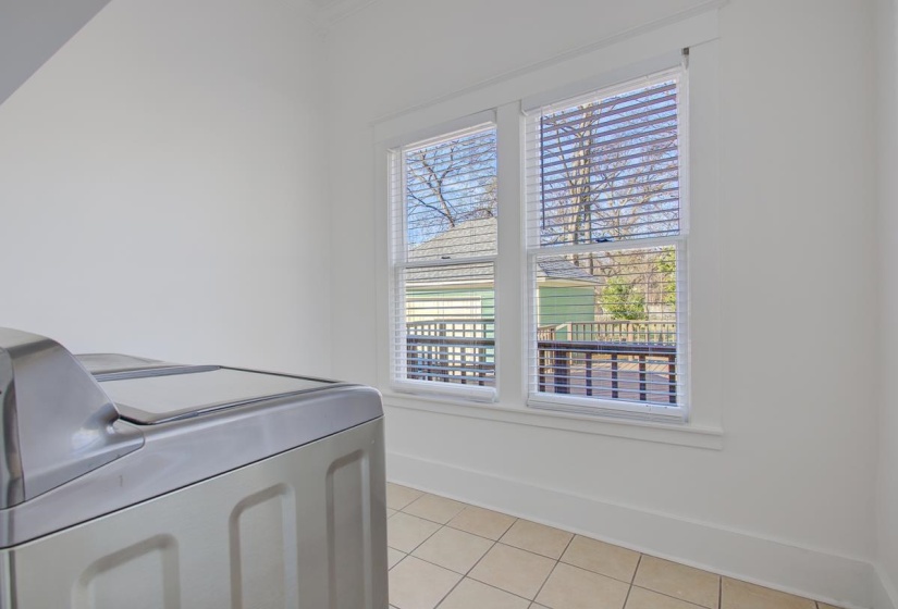 Laundry room featuring baseboards and light tile patterned floors