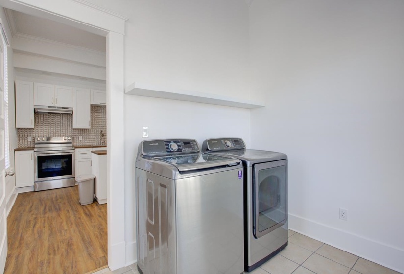 Laundry area with washing machine and dryer and ornamental molding