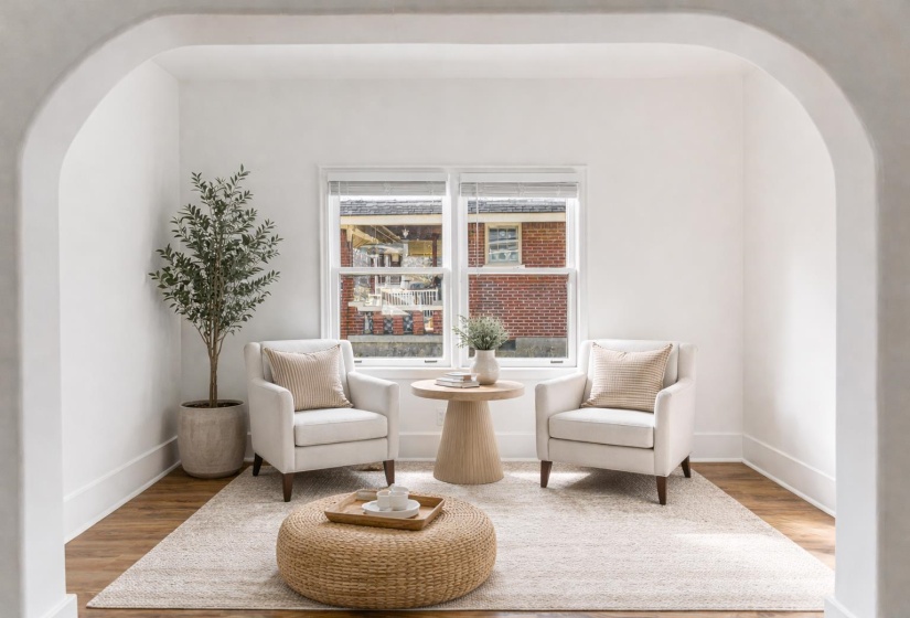 Living area featuring arched walkways and wood finished floors