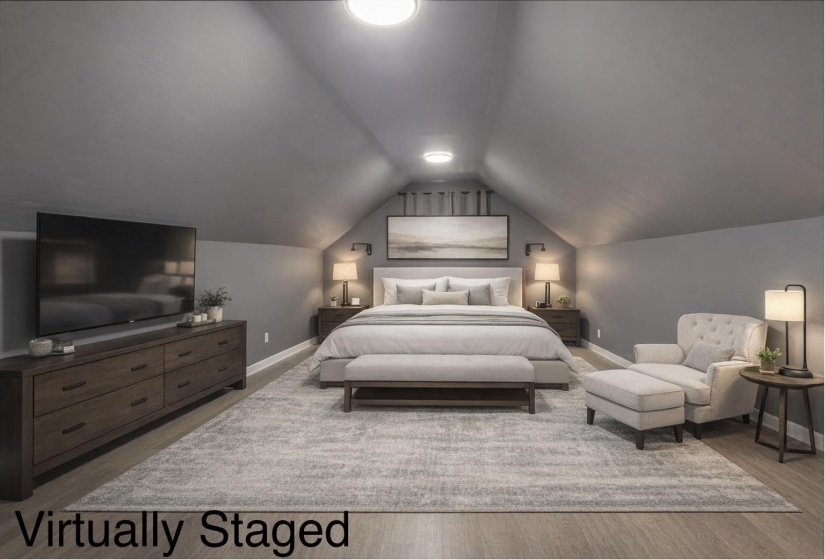 Attic room currently being used as a bonus room but could be used as the primary bedroom with angled ceilings, light wood-finish flooring, and recessed lighting