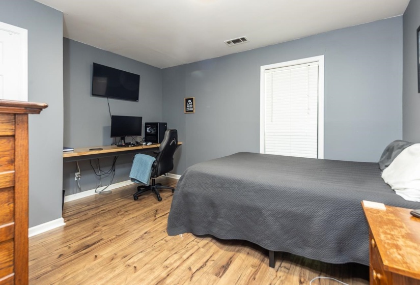Bedroom with light wood-type flooring and a desk