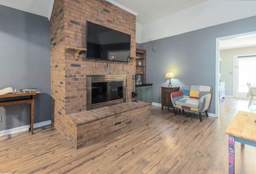 Living area with wood finished floors and a fireplace