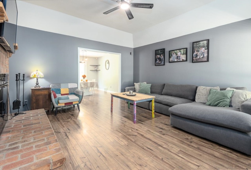 Living area with wood finished floors and a brick fireplace