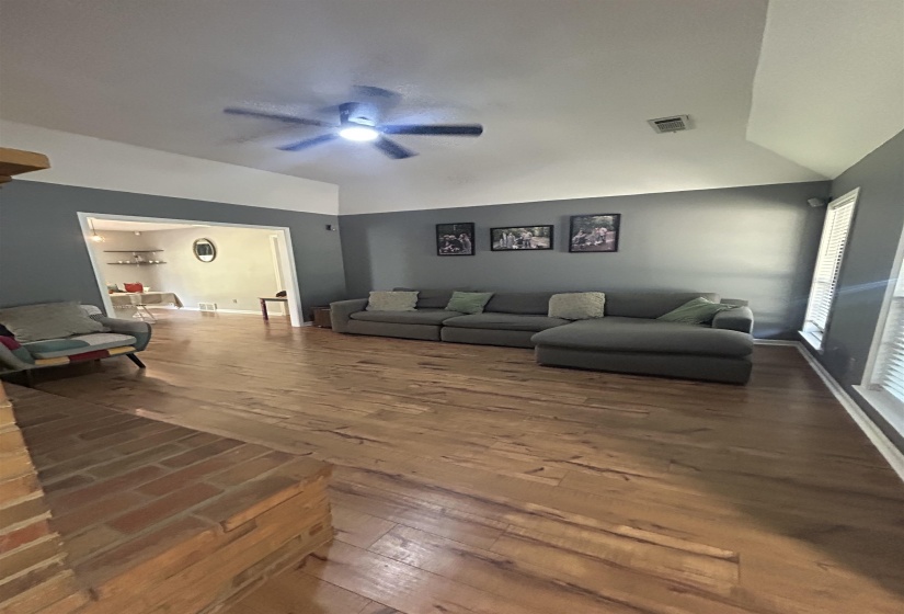 Living room featuring wood finished floors and a ceiling fan