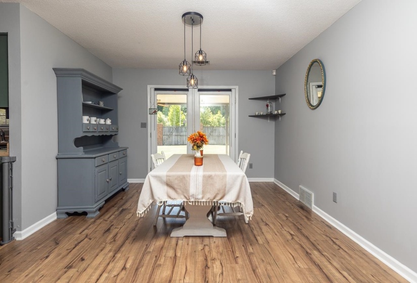 Dining space with dark wood finished floors and a textured ceiling