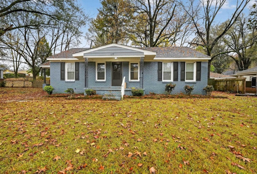 Single story home with brick siding and a porch