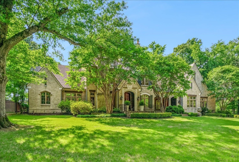 Stone-clad exterior featuring architectural details, gabled rooflines, and multiple windows