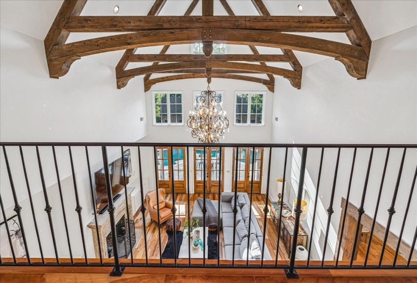 Grand ceiling height featuring exposed wood beams and recessed lighting