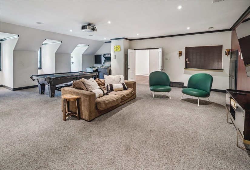 Spacious recreational area featuring recessed lighting, carpeted flooring, and architectural dormer windows