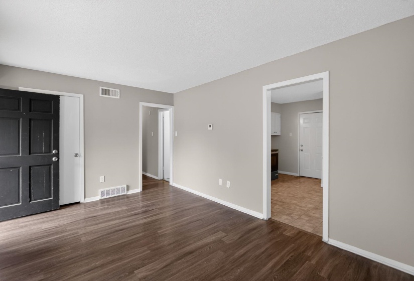 Unfurnished living room with dark wood finished floors and a textured ceiling