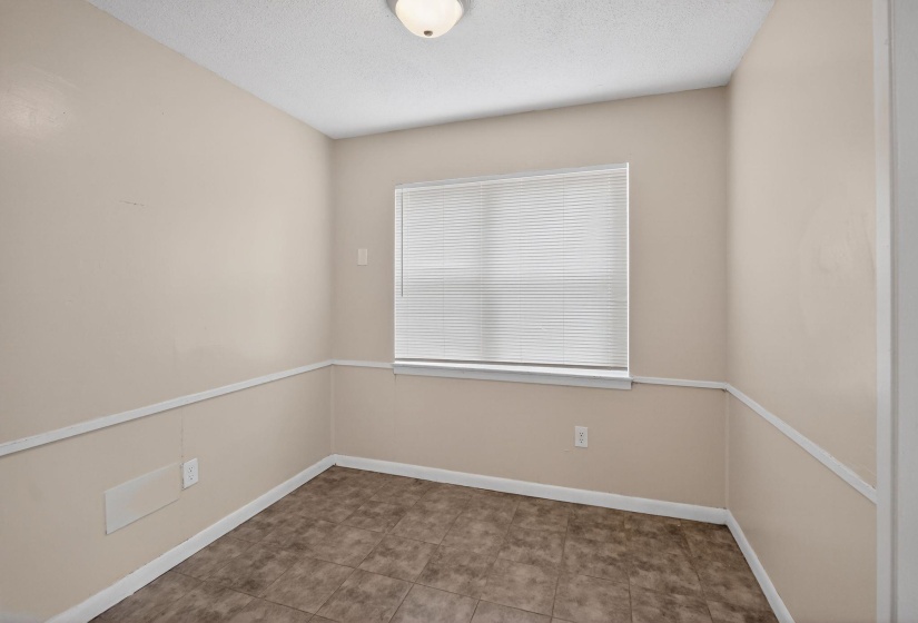 Spare room featuring a textured ceiling and baseboards