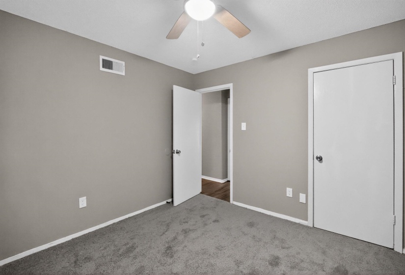 Unfurnished bedroom with carpet floors and ceiling fan