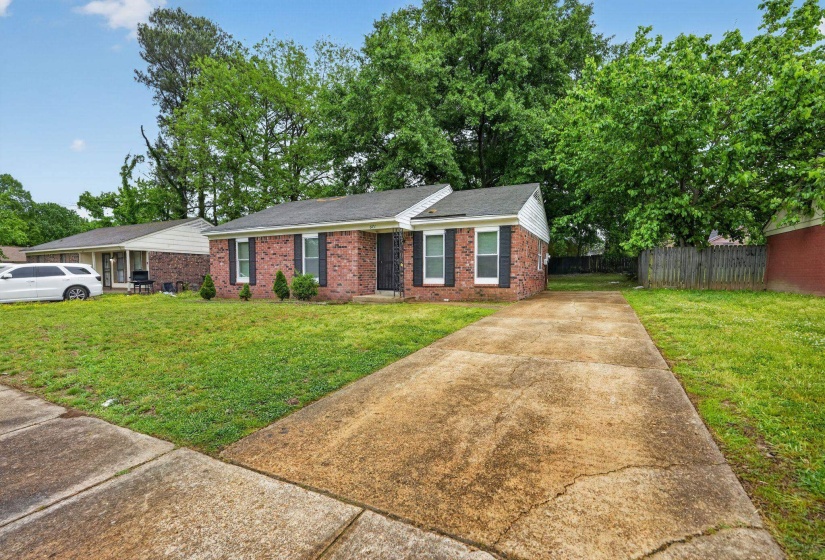 Ranch-style home featuring concrete driveway, brick siding, and a shingled roof