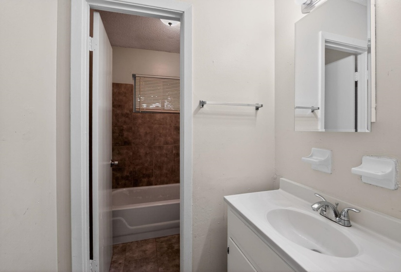 Bathroom with vanity and a textured ceiling