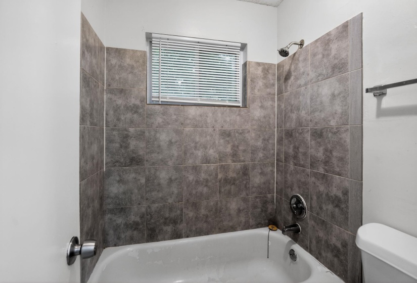 Full bathroom with toilet and shower / bathtub combination