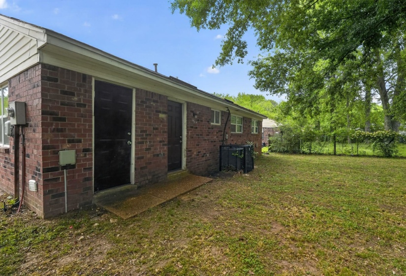 Rear view of house with brick siding