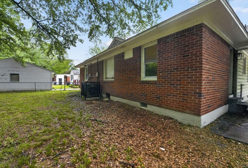 View of property exterior featuring brick siding