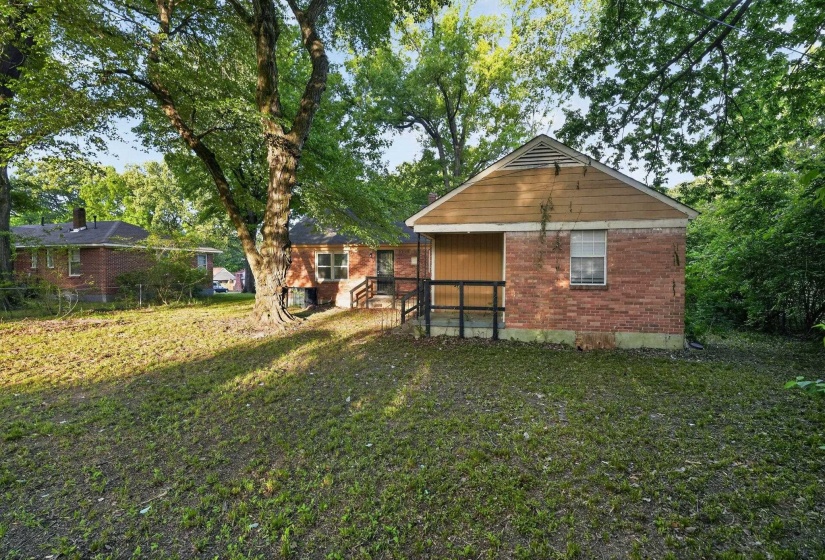 Brick exterior structure with gabled siding and a single window