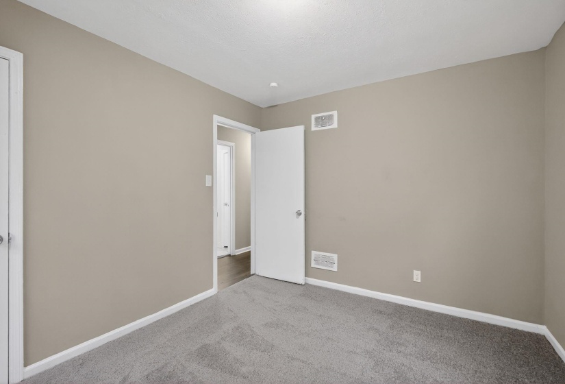 Light gray wall paint complemented by white trim and a neutral gray carpet