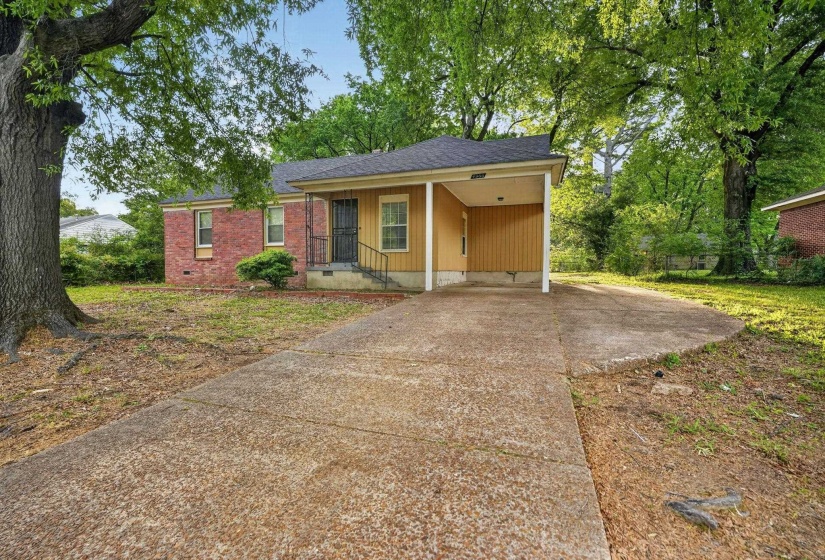 Single-story residence featuring a partial brick facade and siding, a covered front entry with security door, and a single-car carport