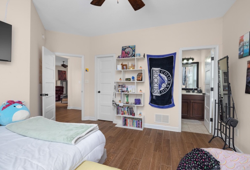 Warm interior featuring wood-finish flooring and a ceiling fan