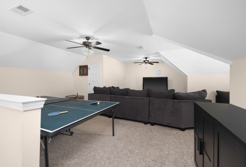 Spacious bonus room featuring vaulted ceilings, recessed lighting, and soft carpet flooring