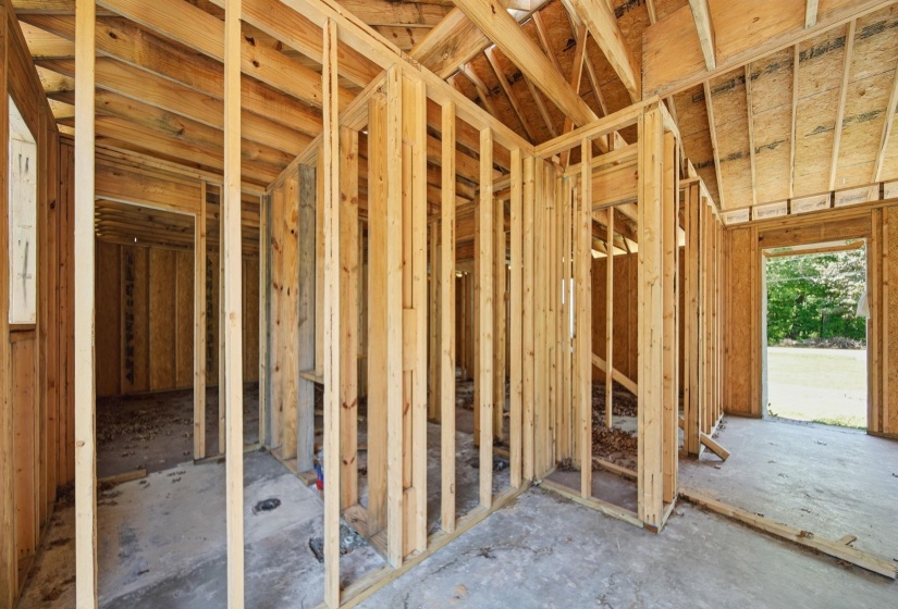 New construction framing featuring exposed wooden studs and ceiling joists
