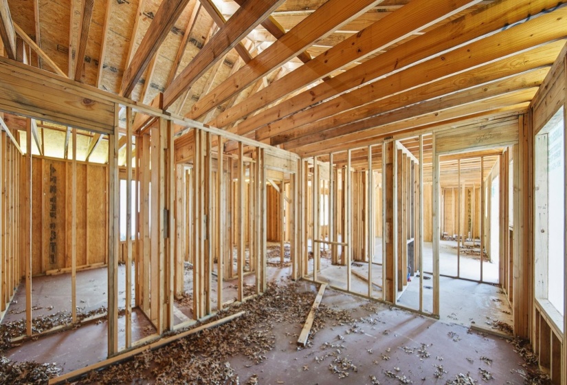 New construction framing showcasing extensive structural wood beams and wall studs