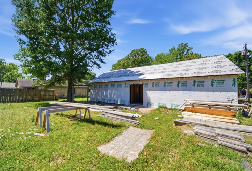 Structure under construction with new roof underlayment and exterior sheathing