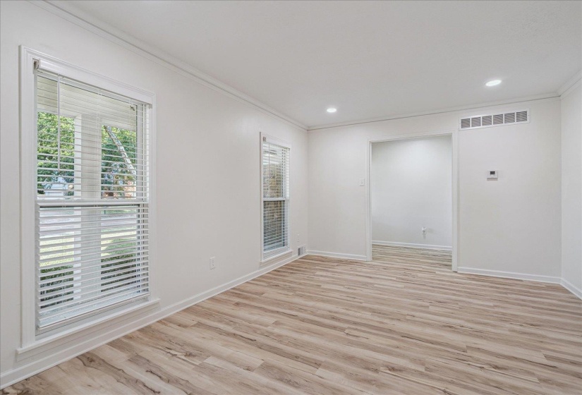 Bright interior space featuring wood-finish flooring, white walls, and recessed lighting