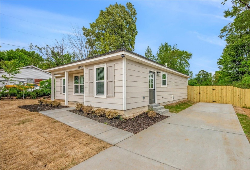 Exterior featuring light-toned siding, white trim, and decorative window shutters