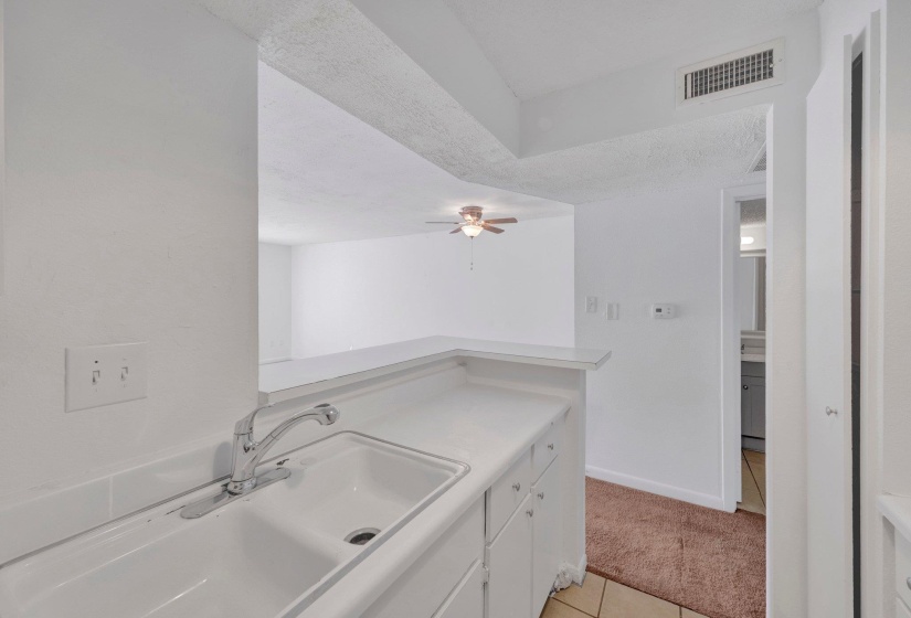 Kitchen counter with integrated sink and chrome faucet