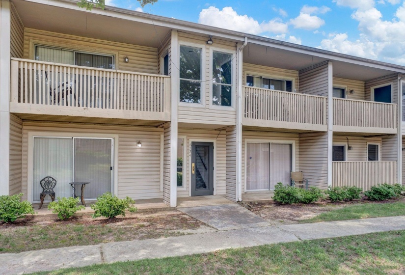Multi-level facade featuring beige horizontal siding