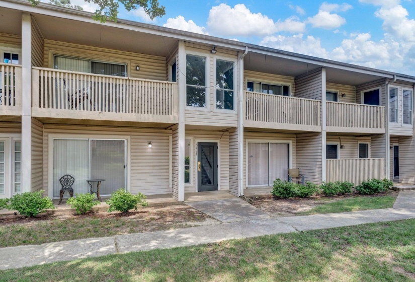 Multi-story facade featuring horizontal siding and individual entryways
