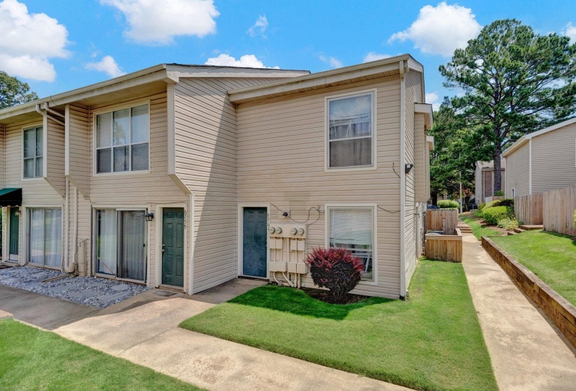 Two-story residential building with light-colored siding