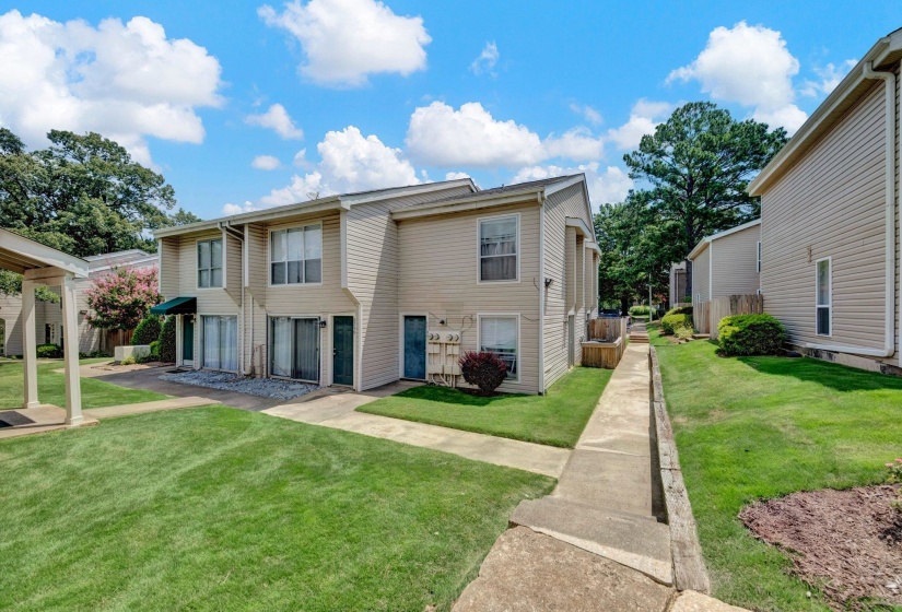 Two-story property with light-colored siding and dark trim accents