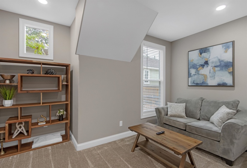 Carpeted living room featuring baseboards and recessed lighting