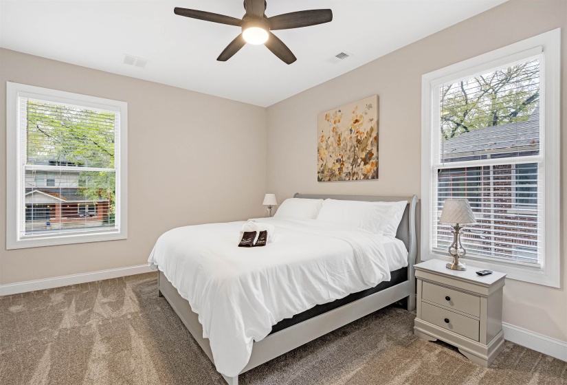 Bedroom with carpet floors, baseboards, and a ceiling fan