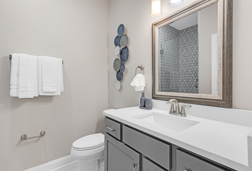 Bathroom with vanity, toilet, a shower, and baseboards