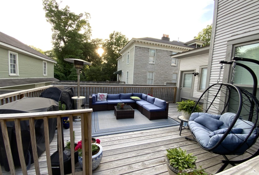 Spacious outdoor deck featuring wooden railing and flooring