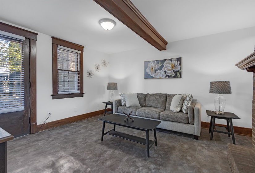 Living room with beam ceiling and baseboards