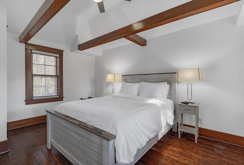 Bedroom with wood finished floors, baseboards, and ceiling fan