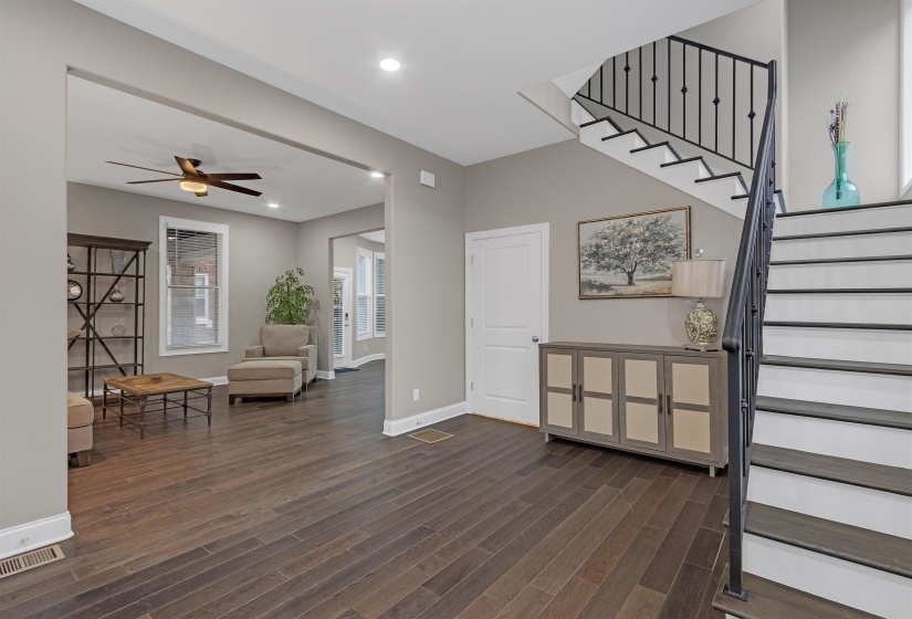 Foyer entrance featuring stairs, dark wood finished floors, ceiling fan, baseboards, and recessed lighting