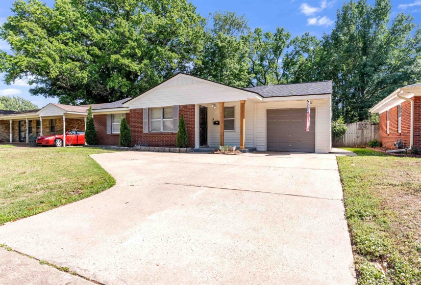 Brick and siding exterior featuring a covered entryway, a single-car garage, and a concrete driveway