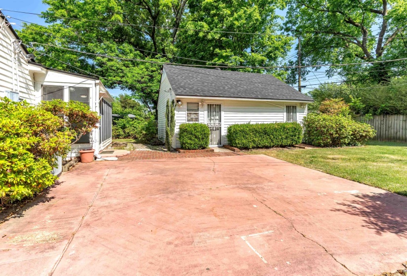 Expansive concrete patio with brick-patterned finish