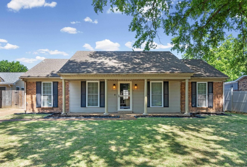 Brick and siding exterior with a covered front porch featuring four columns